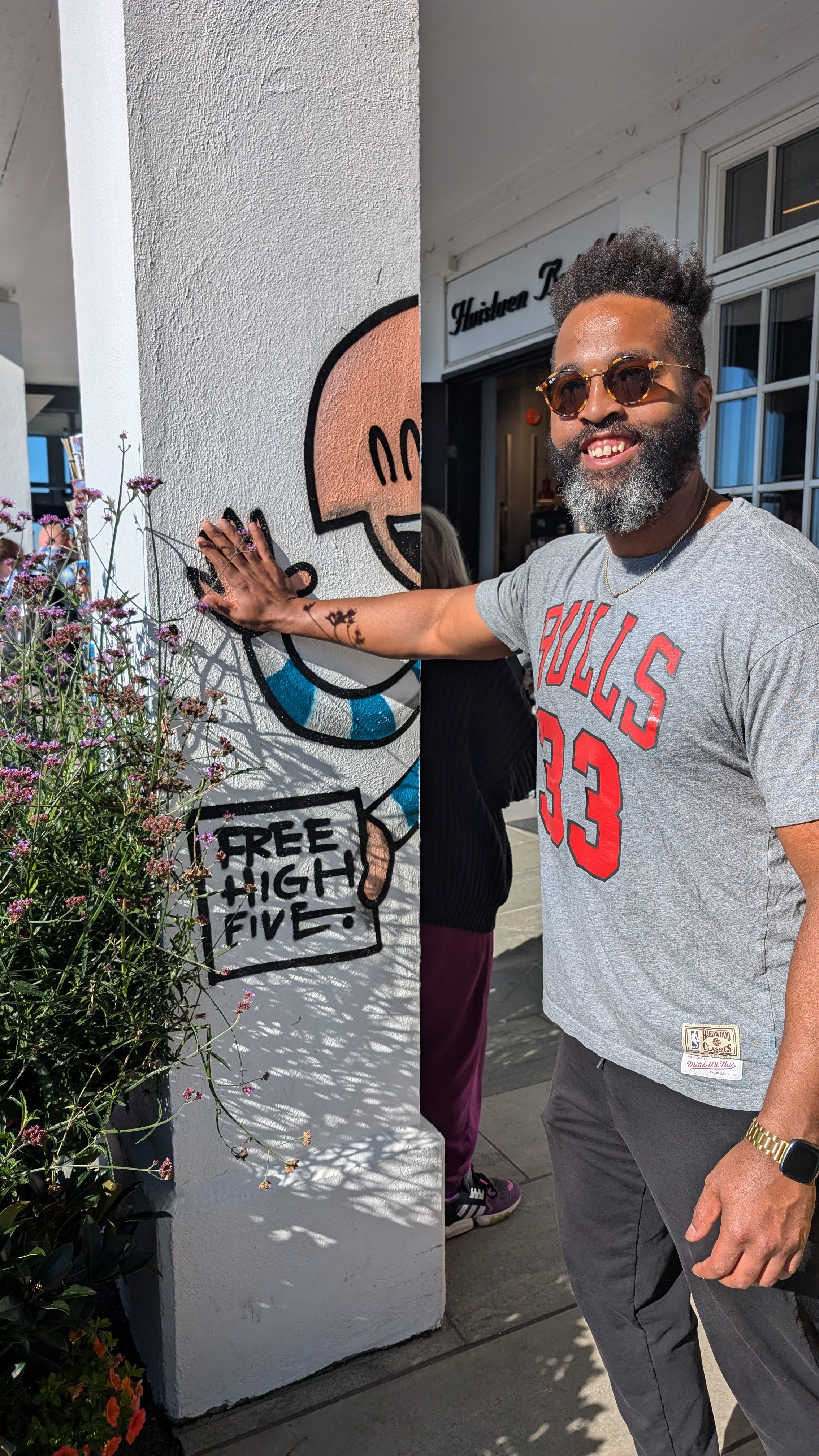A photo of Jovial Solutions CEO, Jared Jarell Jones, providing a free high five in Bergen, Norway